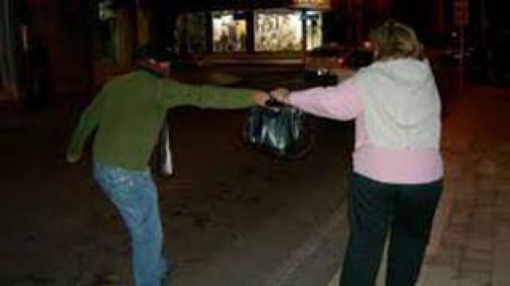 Motochorros armados le llevan la cartera a una mujer