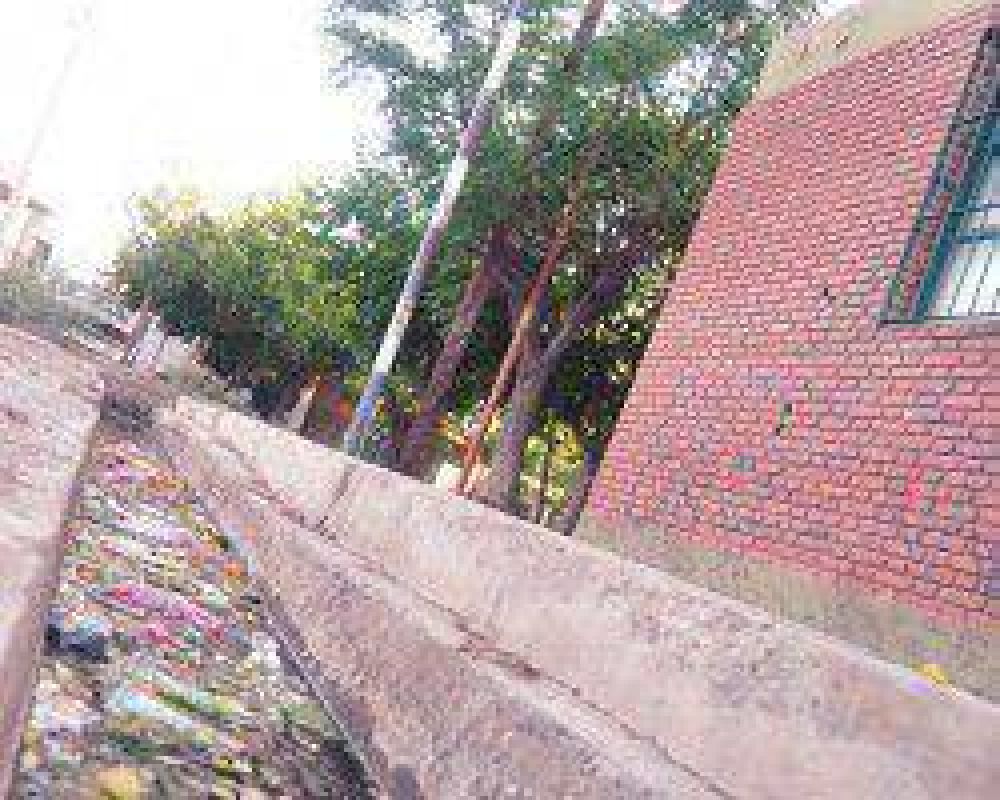 Por la acequia del frente de una escuela viajan l�quidos cloacales