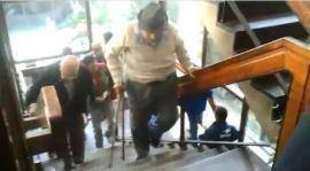 D�cada ganada en el Banco Naci�n: los abuelos suben con muletas escal�n por escal�n 