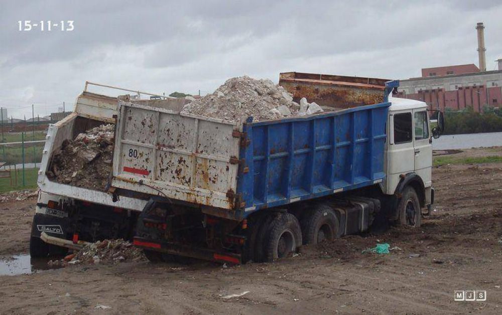 Dos camiones que siguen sacando escombros de la Reserva del Puerto se atascaron en el barro